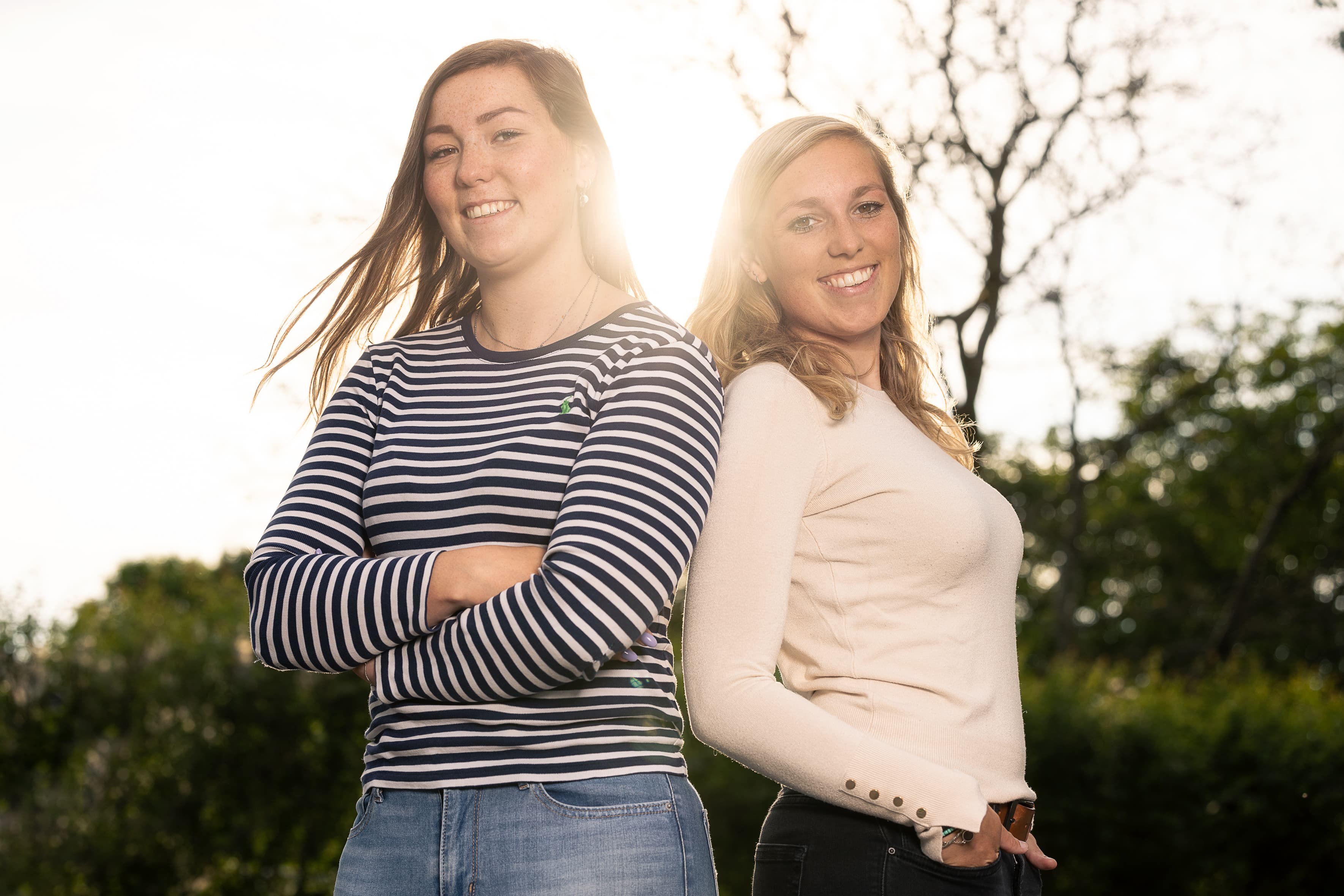 Twee zussen met de zon die tussen hun schijnt